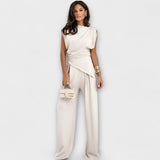 Set with asymmetric design and dramatic shoulders